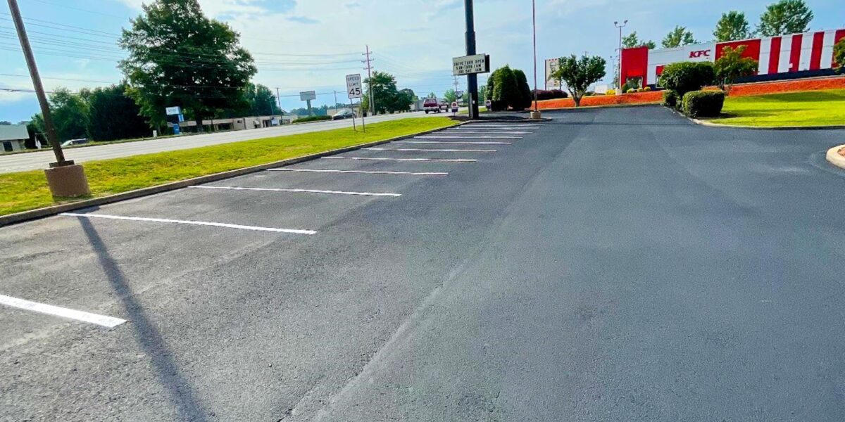 Freshly paved commercial asphalt parking lot done by Mad Jack's Asphalt & Concrete, LLC