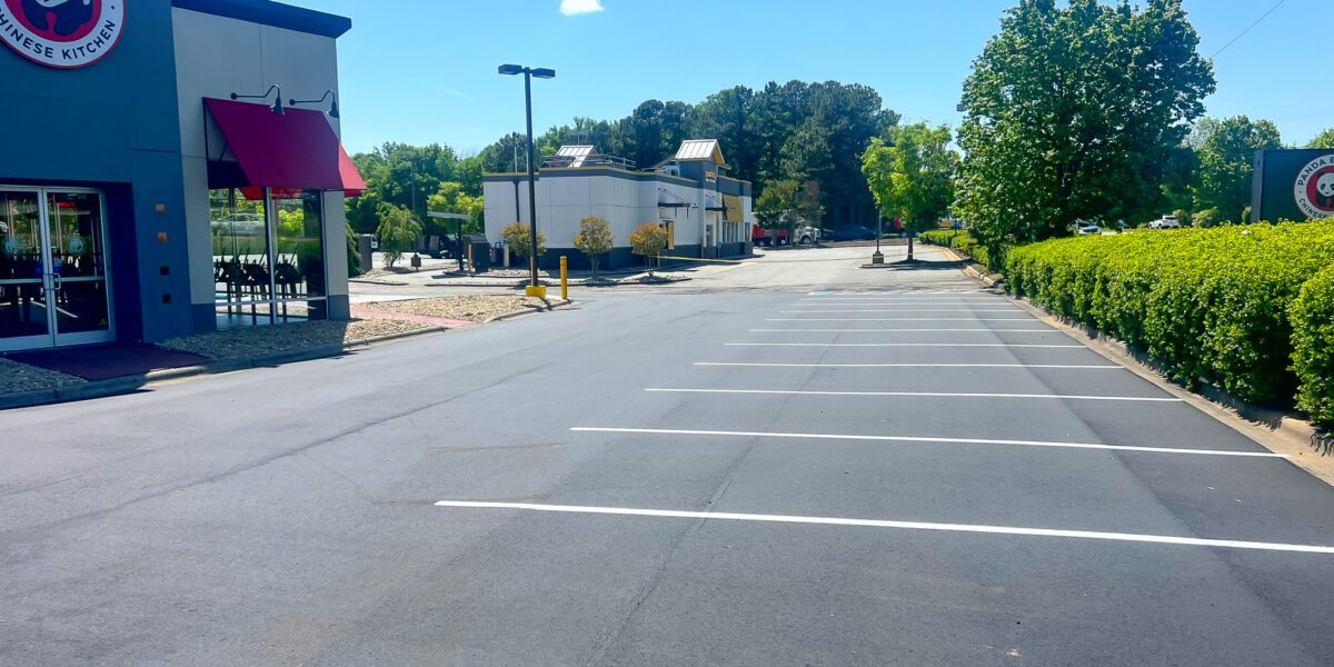 Freshly sealed and striped asphalt parking lot Mad Jack's Asphalt & Concrete, LLC