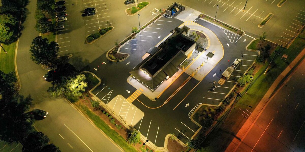 Aerial view of freshly paved commercial asphalt parking lot done by Mad Jack's Asphalt & Concrete, LLC