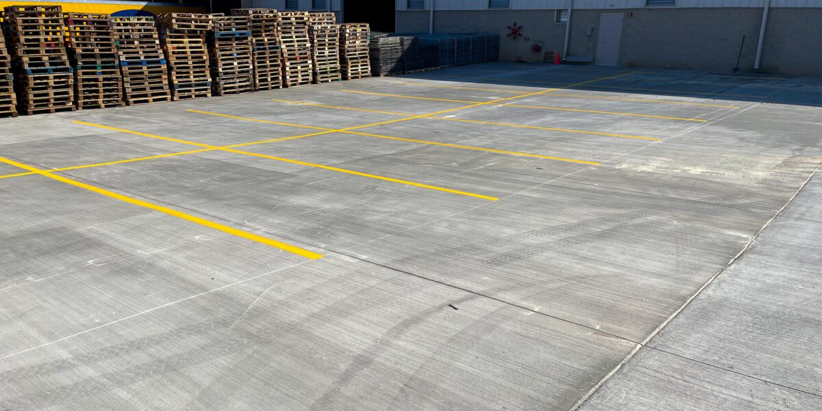 Freshly marked concrete parking lot poured by Mad Jack's Asphalt & Concrete, LLC