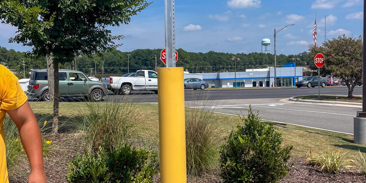 New concrete post poured by Mad Jack's Asphalt & Concrete, LLC for handicap parking spot sign
