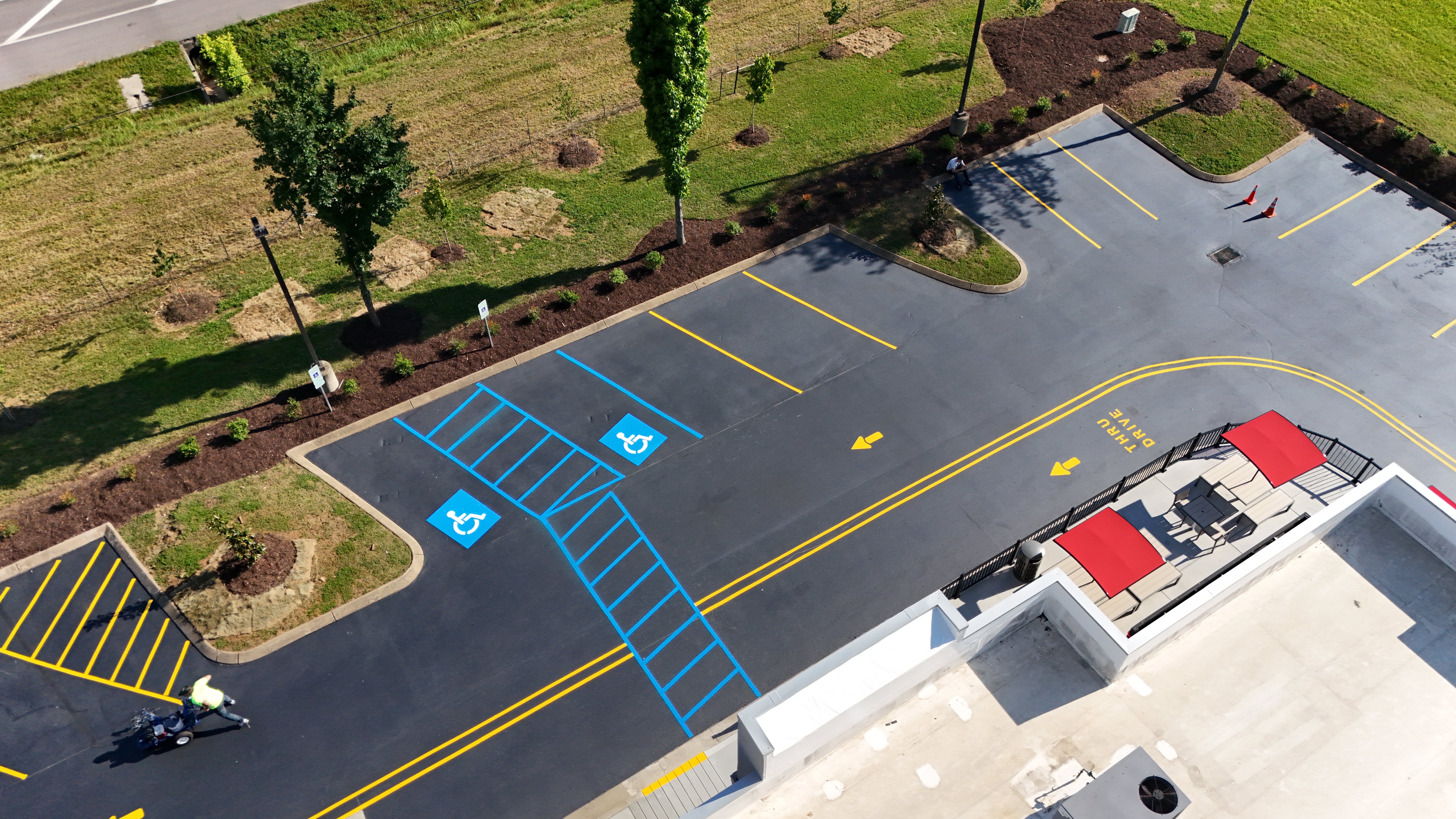 aerial photo of an asphalt seal coated with lot stripiong