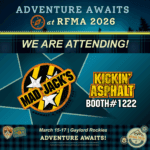 Promotional graphic announcing Mad Jack’s Asphalt & Concrete attending RFMA 2026. The design features bold outdoor adventure styling with teal and plaid accents. Text reads “Adventure Awaits at RFMA 2026” and “We Are Attending.” The Mad Jack’s logo appears alongside the phrase “Kickin’ Asphalt, Booth #1222.” Event details at the bottom read “March 15–17 | Gaylord Rockies.” Adventure-themed badge icons are displayed throughout the design.
