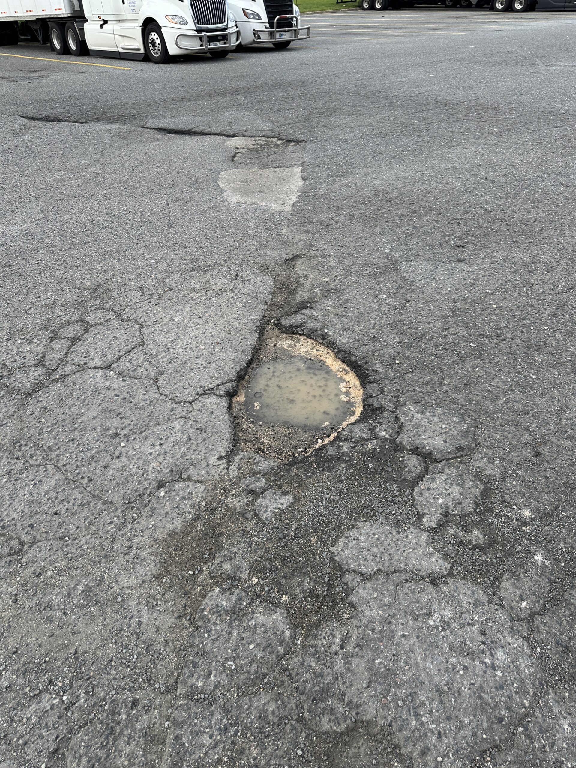 Photo of a pothole in a parking lot