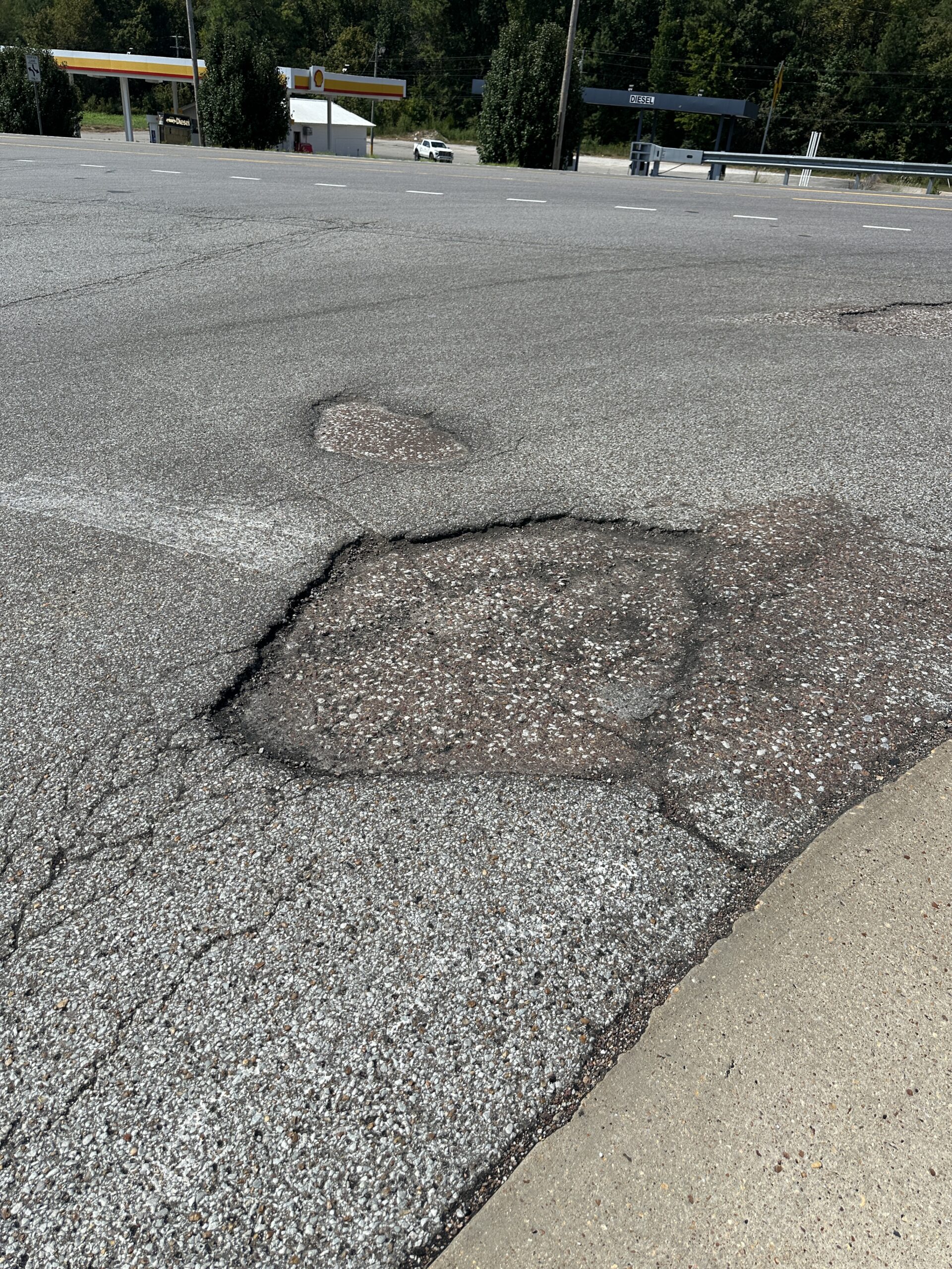 Photo of a pothole in a parking lot